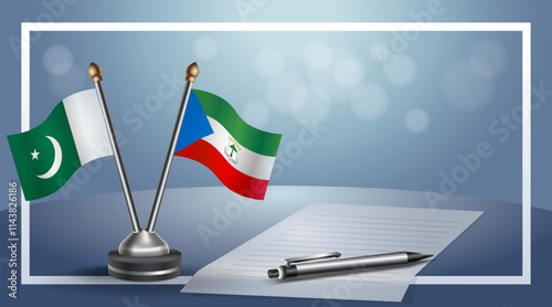 Pakistan and Equatorial Guinea National flags on small table with bokeh background, cooperative relationship