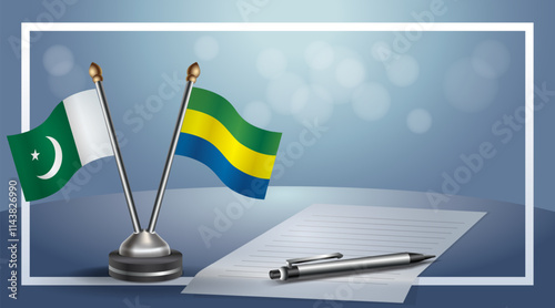 Pakistan and Gabon National flags on small table with bokeh background, cooperative relationship