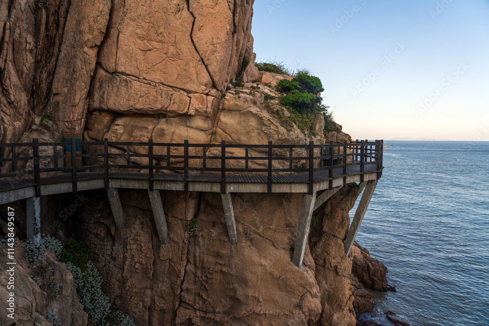 Fototapeta premium Scenic Coastal Pathway Overlooking Tranquil Ocean and Majestic Cliffs