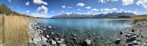 Crystal-clear waters of Lake Pukaki reveal stunning blue hues under a bright sky in New Zealand