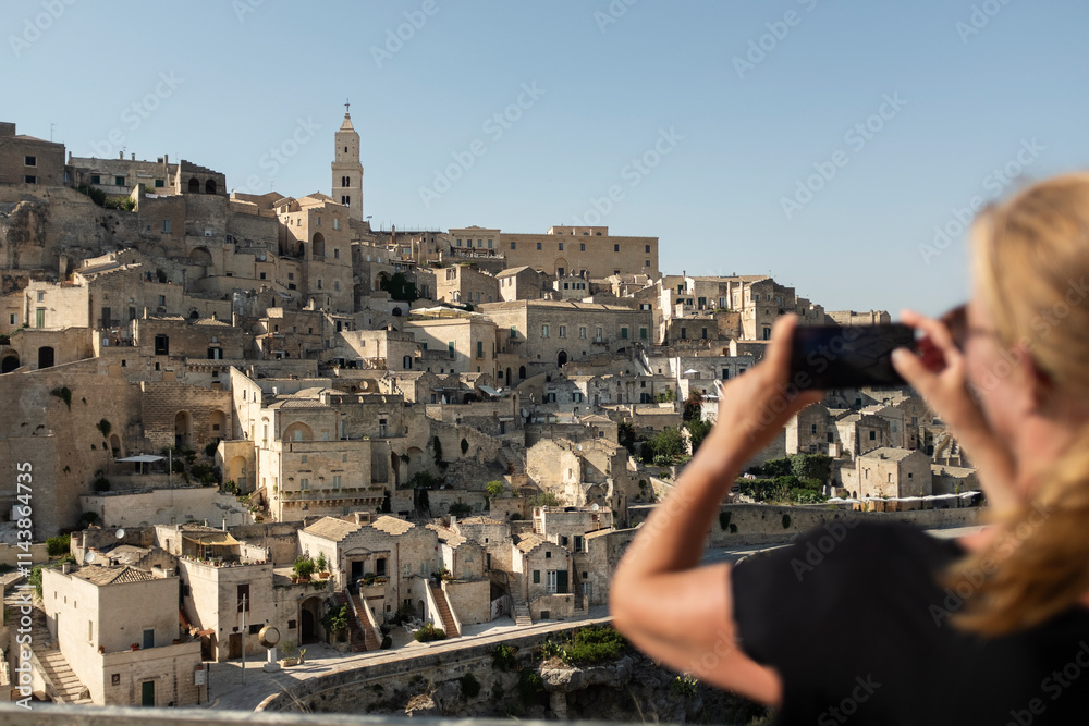 © Johnér - Cropped image of woman taking photos of townscape © Johnér - Cropped image of woman taking photos of townscape