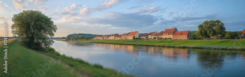 Historic towns along the Elbe River in Germany during a serene sunset reflection
