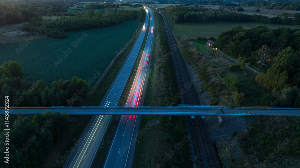 custom made wallpaper toronto digitalDrone view of bridge above two lane illuminated highway amidst agricultural field at dusk