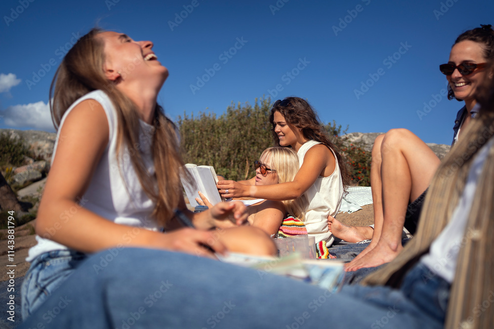 Female friends spending leisure time and having fun at picnic Female friends spending leisure time and having fun at picnic