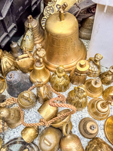 A collection of antique brass bells of various shapes and sizes. High quality photo photo