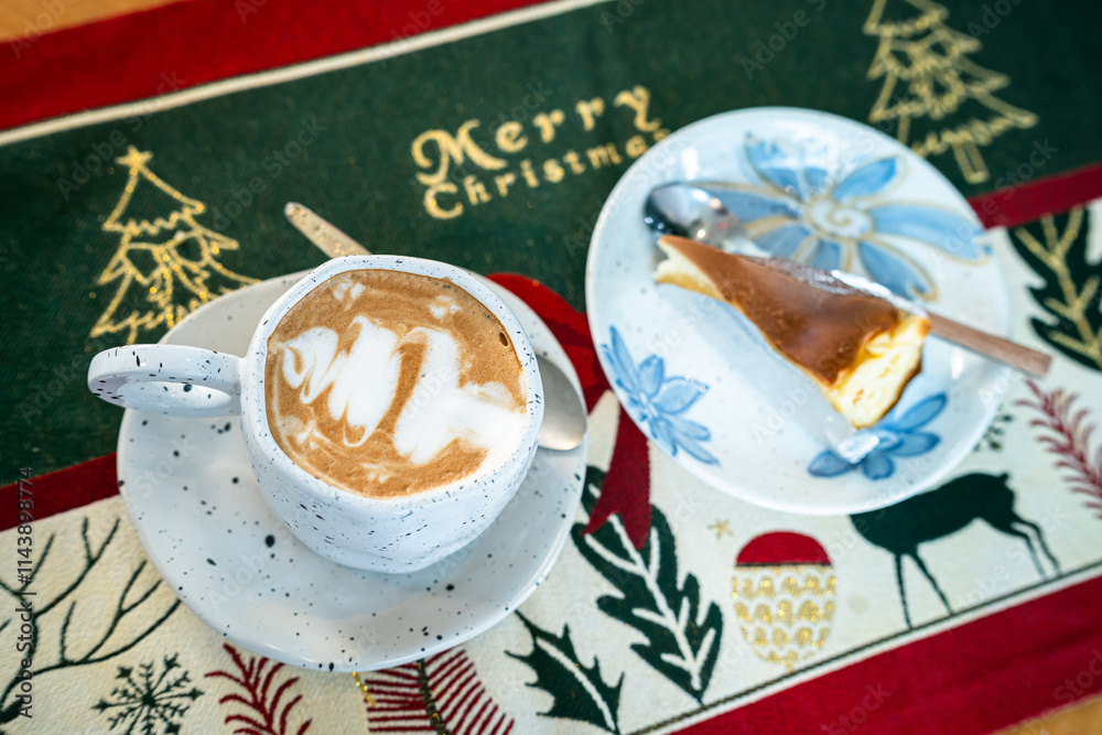 Close up of Hot coffee latte with latte art milk foam in cup mug and Homemade burnt cheesecake with Xmas decors and Xmas tree baubles on wood desk Celebrating Merry Christmas and New year,Merry x-mas