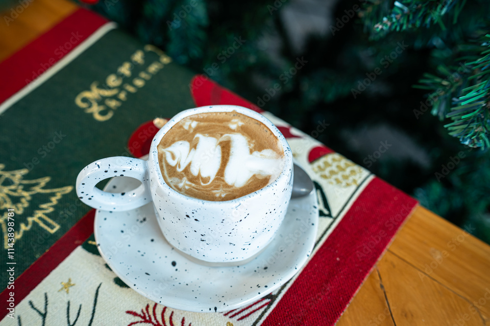 Close up of Hot coffee latte with latte art milk foam in cup mug with Xmas decors and Xmas tree baubles on wood desk Celebrating Merry Christmas and New year,Merry x-mas