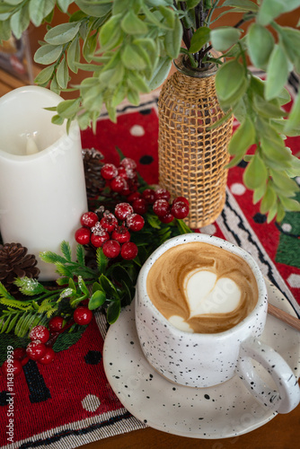 Obraz na płótnie Close up of Hot coffee latte with latte art milk foam in cup mug with Xmas decors and Xmas tree baubles on wood desk Celebrating Merry Christmas and New year,Merry x-mas w salonie