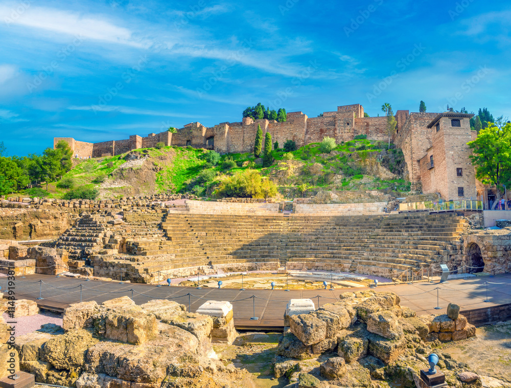 Remains of the ancient roiman theatre of Malaga right under the ruins of the Alcazaba palace towers and outer walls, Malaga, Andalusia (Andalucía), Spain