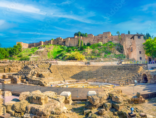 Obraz na płótnie Remains of the ancient roiman theatre of Malaga right under the ruins of the Alcazaba palace towers and outer walls, Malaga, Andalusia (Andalucía), Spain w salonie
