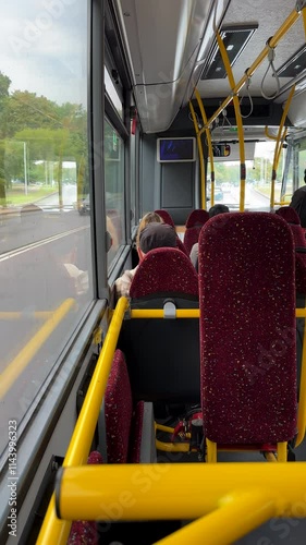 Vertical shot. Riding local bus in Klaipeda city, Lithuania; selective focus inside of bus.