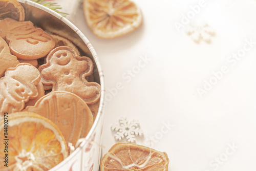 Christmas gingerbread cookies in a tin filled with gingerbread cookies and dried orange slices. Festive food, culinary, festive touch. Christmas and New Year traditions concept, real photo