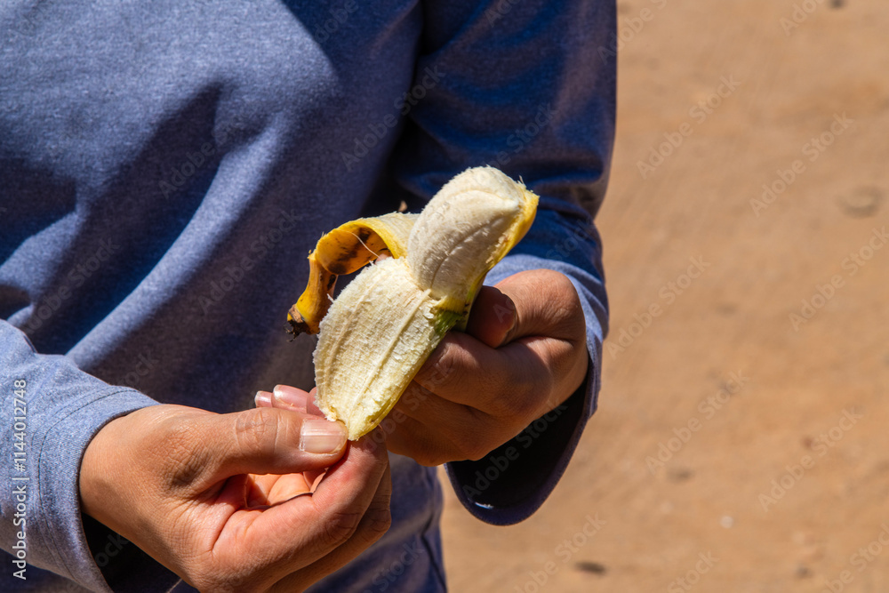 peeling the banana at the hand