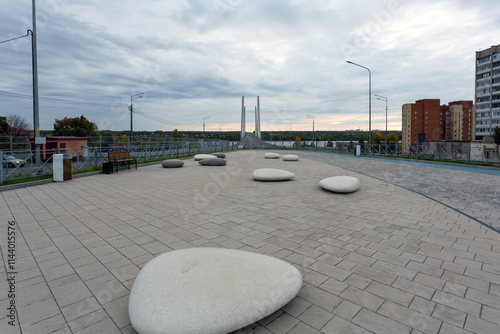 Square with stones on Arkhangelskaya street in Cherepovets, Arkhangelsky bridge over the Sheksna river, Vologda region, Russia