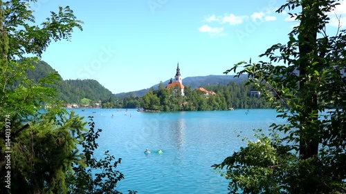 Wallpaper Mural Tranquil lake bled in slovenia features an iconic island church surrounded by pristine blue waters and vibrant green trees Torontodigital.ca