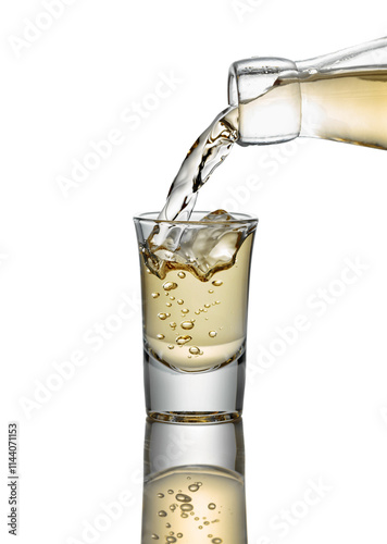 Gold liquor pouring into a glass on a white background.