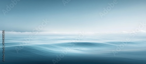 Tranquil coastal horizon with soft waves and serene blue tones creating a peaceful seascape atmosphere at dawn or dusk