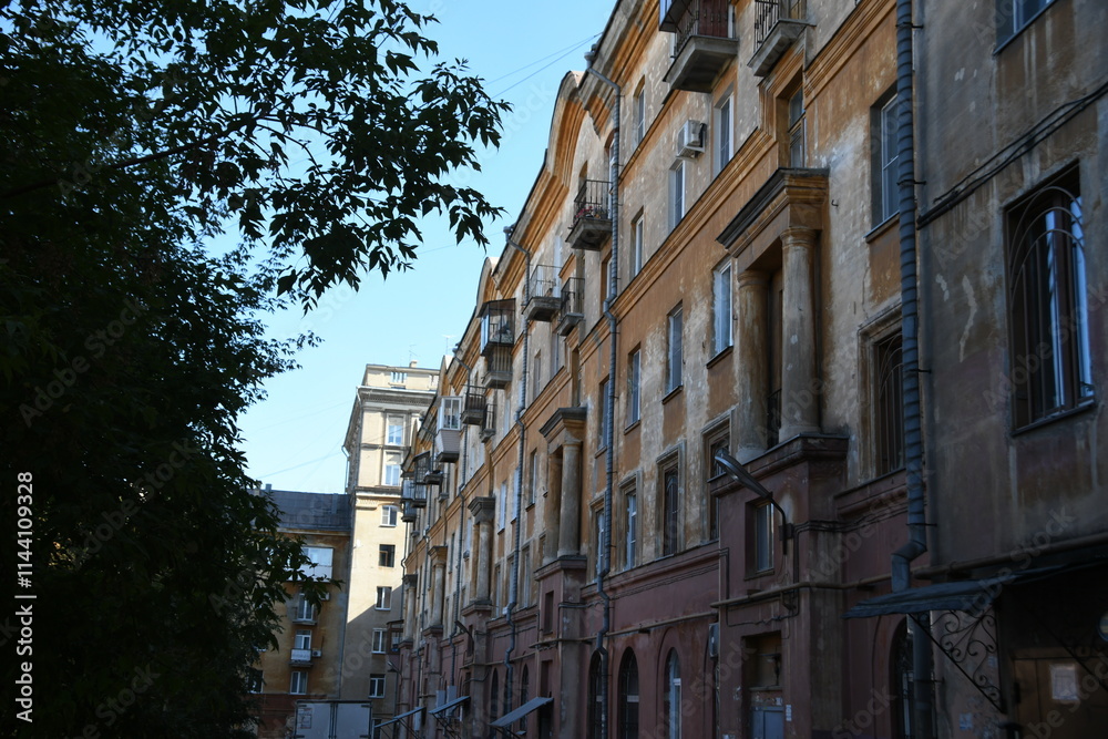Architecture of old Soviet Union houses in Stalin's Empire style. Exterior of the facade of a vintage residential building in Russia