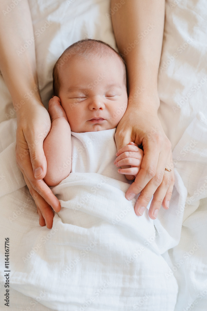 Baby sleeping in arms of his loving mother. Baby care. Baby sleeping in arms of his loving mother. Baby care.
