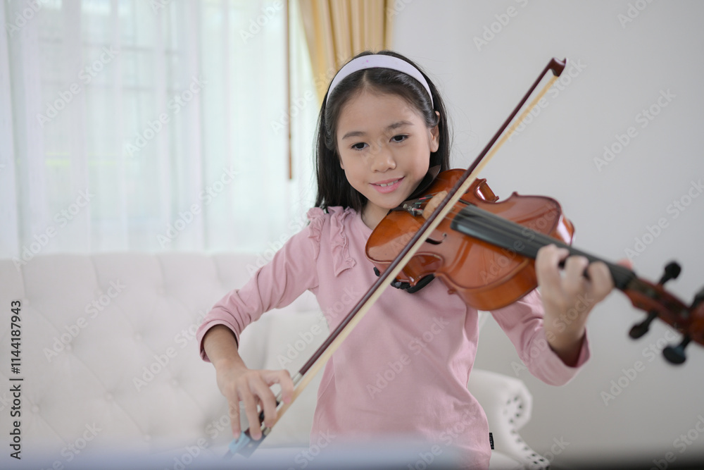 A girl violinist plays and practices the violin at home A girl violinist plays and practices the violin at home
