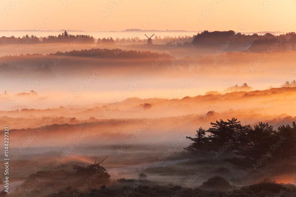 Beautiful sunrise at Lighthouse of Rubjerg Knude. Denmark north coast with wonderfully illuminated fog. Beautiful sunrise at Lighthouse of Rubjerg Knude. Denmark north coast with wonderfully illuminated fog.