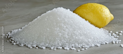 Pile of salt crystals next to a lemon.
