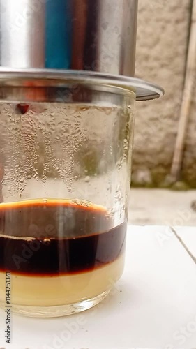 The barista serves coffee with a Vietnam drip coffee maker. Vietnam drip coffee.