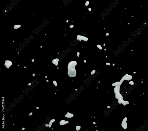 White bubble foam fly in many shape form and splashing in air. Bubble foam use to clean wash toilet kitchen bathroom. Black background isolated, texture element object