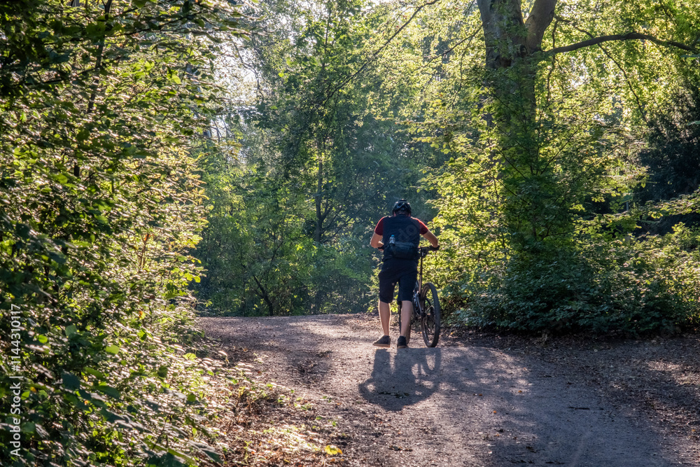 Obraz premium A day in forest. Cross biker struggling in woods.