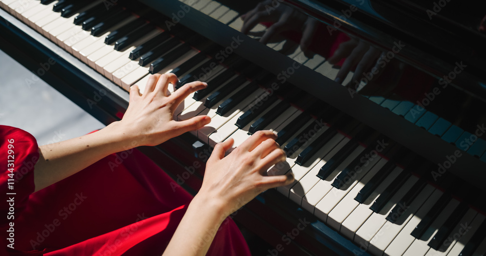 Fototapeta premium Close Up on Hands of a Talented Anonymous Pianist Making a Masterful Performance on a Grand Piano. Under Soft Stage Lights, Female Fingers Move Across the Keys, Creating Beautiful Classical Music