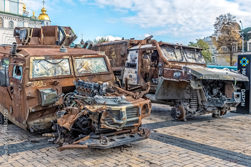 Two destroyed armored vehicles exhibited at the Destroyed Russian Military Equipment Exhibition on Mykhailivska Square, Kyiv. Kyiv, Ukraine - October 27, 2023 photo