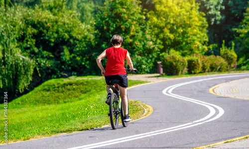 Wallpaper Mural Cyclist ride on the bike path in the city Park Torontodigital.ca