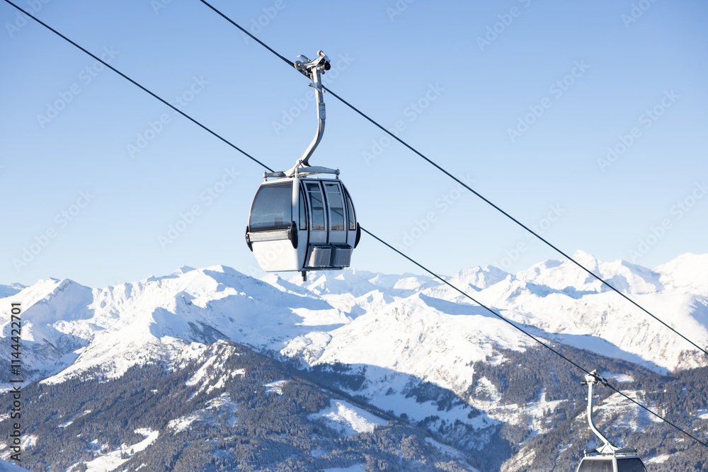 Obraz premium White cable car in a ski resort in the Austrian Alps. Gastein valley