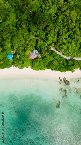 Sun reflection over Tiamban Beach and Nonok Beach Resort. Romblon Island. Romblon, Philippines. Vertical view. photo