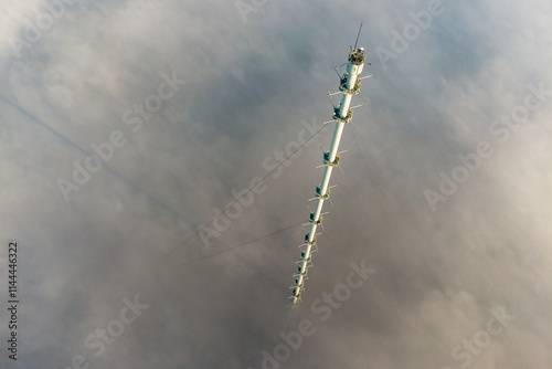 Aerial view of 300-meter meteorological mast in fog and clouds. Obninsk, Russia. November 2021 photo