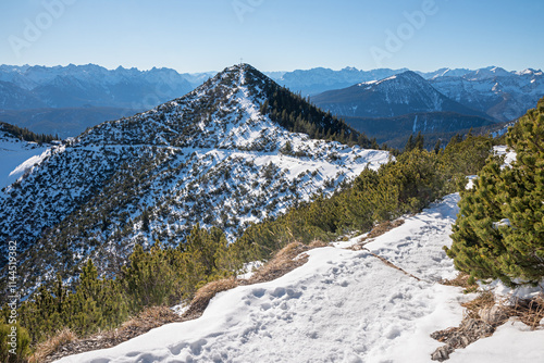 view from herzogstand to Martinskopf summit with mountain cross, bavarian alps in winter photo