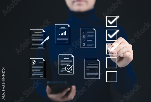 Quality Assurance and Document Control with Checklist Icons. A person marks off items on digital checklist, representing quality assurance and document control processes, verification, and compliance. photo