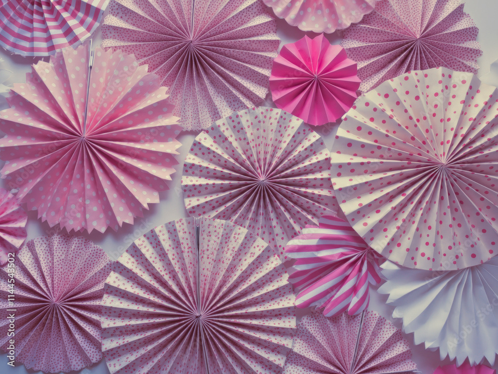 Colorful paper fans in shades of pink, perfect for party decorations Colorful paper fans in shades of pink, perfect for party decorations