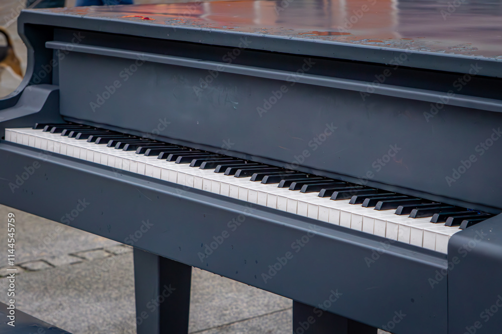 a piano for playing placed in the city center on the street. a piano for playing placed in the city center on the street.