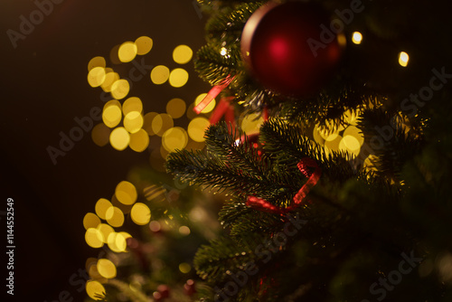 Festive Christmas tree adorned with ornaments and warm lights creates a cozy holiday atmosphere