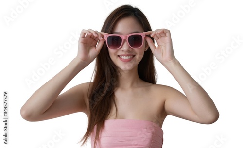 A smiling Asian woman with long brown hair wears pink sunglasses and a strapless pink top against a white background.