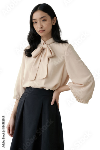 A young Asian woman with shoulder-length black hair wears a peach blouse with a bow and black skirt.