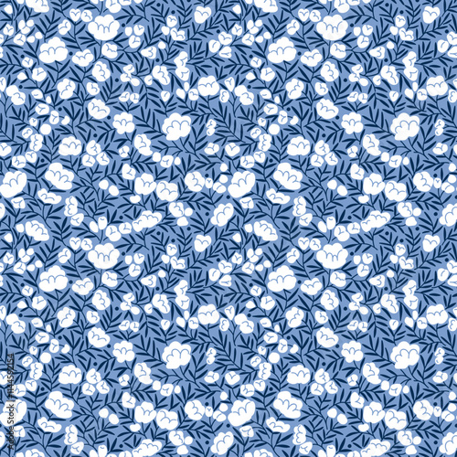 Beautiful floral pattern in small abstract roses flowers. Small white flowers. Blue background. Ditsy print. Floral seamless background. Vintage template for fashion prints. Stock pattern.
