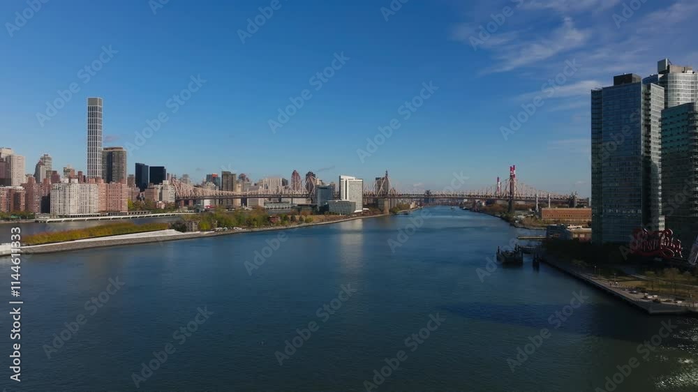 Aerial perspectives highlight Roosevelt Island, with the East River flowing nearby, iconic Midtown Manhattan skyline on the left and Queens borough on the right Aerial perspectives highlight Roosevelt Island, with the East River flowing nearby, iconic Midtown Manhattan skyline on the left and Queens borough on the right