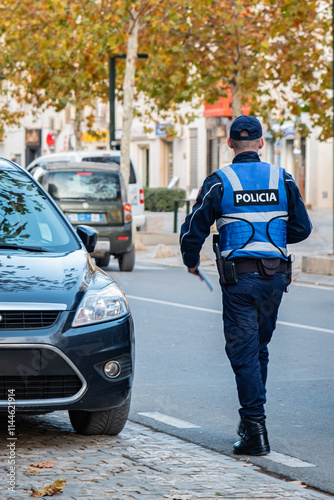 Police officer on duty on a city center street during special event.