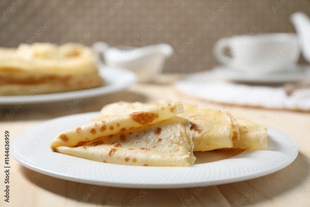 Tasty crepes on wooden table, closeup view Tasty crepes on wooden table, closeup view