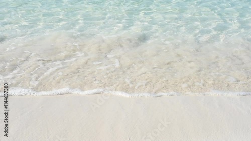 HD video close-up shot of sea waves gently breaking on the white sand of a tropical beach in Mexico. Perfect for travel ads, resort promotions, and tourism campaigns