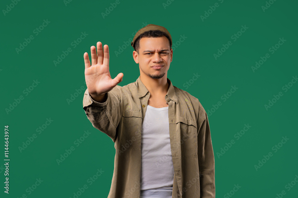 Serious man showing rejecting gesture by stop palm sign. Not allow, prohibition Serious man showing rejecting gesture by stop palm sign. Not allow, prohibition