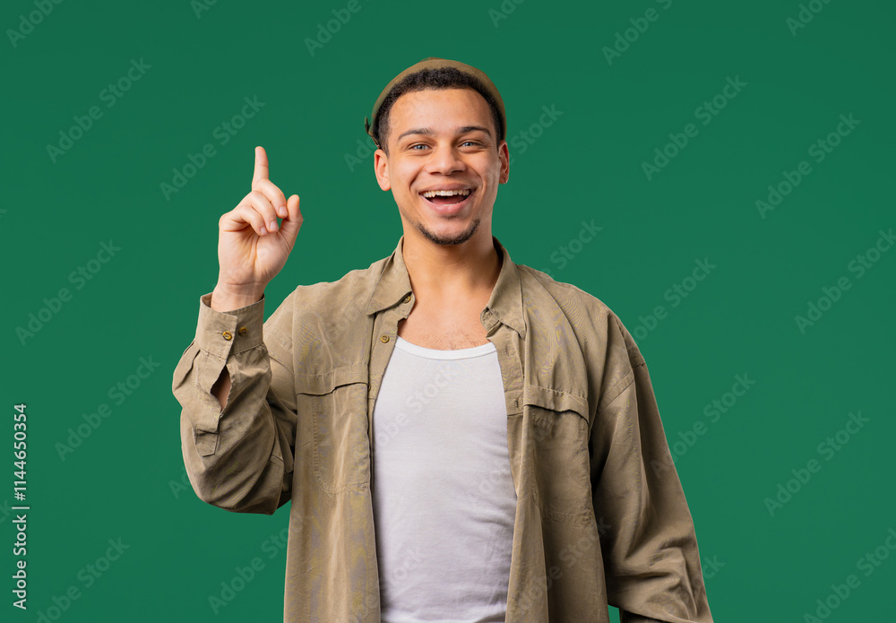 Brainy man having idea eureka moment, pointing finger up on green. Solution. Brainy man having idea eureka moment, pointing finger up on green. Solution.