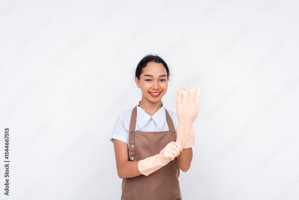 Smiling housekeeper wearing protective gloves for cleaning in a professional service role Smiling housekeeper wearing protective gloves for cleaning in a professional service role